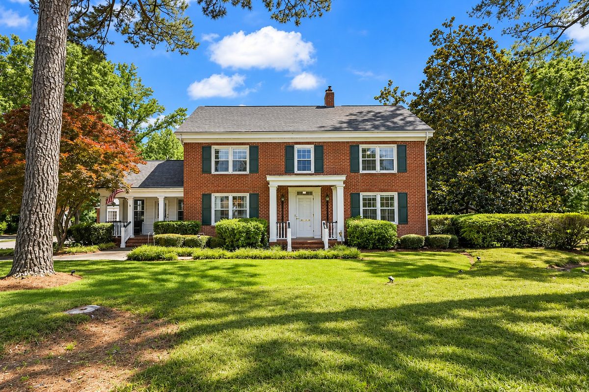 A two story brick Colonial home with mature landscaping in Loris